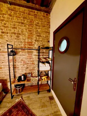 a room with a brick wall and a door at Karakoy Port House in Istanbul
