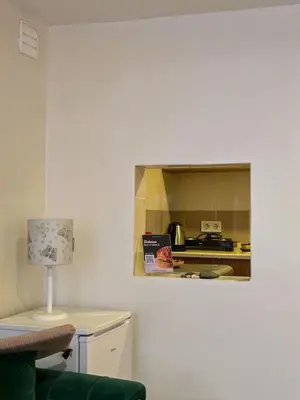 a small kitchen with a stove and a table with a lamp at Karakoy Port House in Istanbul