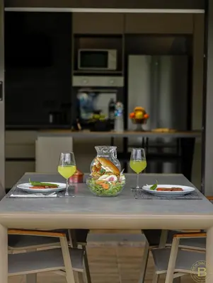 a table with two plates of food and two glasses of wine at New Balturk Villas Sapanca in Sapanca