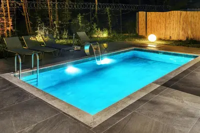 a swimming pool in the middle of a yard at night at New Balturk Villas Sapanca in Sapanca
