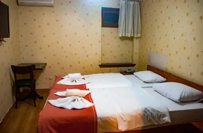 a bedroom with two beds with towels on them at Istanbul Irish Hotel in Istanbul