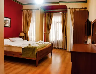 a bedroom with a bed in a room with red walls at Istanbul Irish Hotel in Istanbul