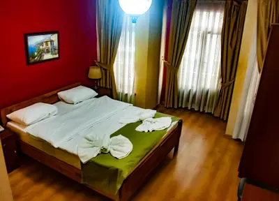 a bedroom with a bed with white sheets and pillows at Istanbul Irish Hotel in Istanbul