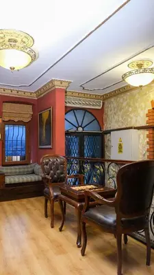 a living room with chairs and a table at Istanbul Irish Hotel in Istanbul