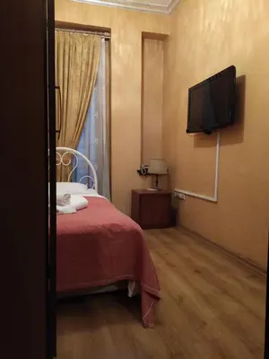 a bedroom with a bed and a flat screen tv at Istanbul Irish Hotel in Istanbul