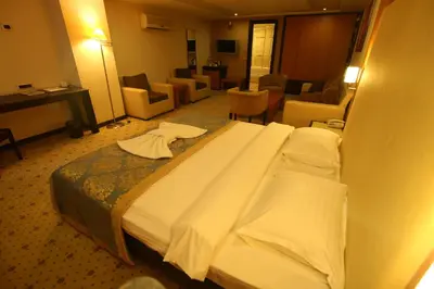 a hotel room with a large bed and a living room at ZEO HOTEL merter in Istanbul