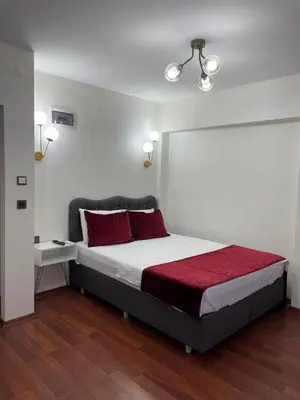 a bedroom with a large bed with red pillows at PANORAMA CITY SUITE in Istanbul