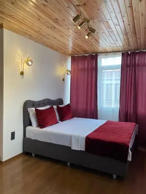 a bedroom with a large bed with red pillows at PANORAMA CITY SUITE in Istanbul