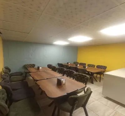 a conference room with wooden tables and chairs at Taksim Soushian Hotel in Istanbul