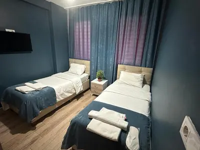 two beds in a room with blue walls at Taksim Soushian Hotel in Istanbul
