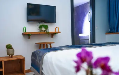 a bedroom with a bed and a tv on a wall at The Gate Kadıköy Downtown in Istanbul