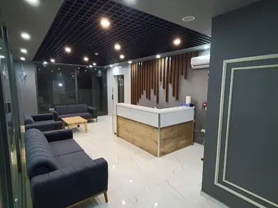 a lobby with couches and a reception desk in a building at ÖZTÜRKS HOTEL in Istanbul