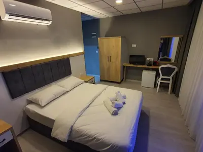 a bedroom with a bed with two towels on it at ÖZTÜRKS HOTEL in Istanbul