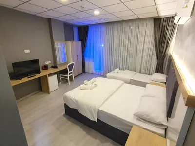 a hospital room with two beds and a television at ÖZTÜRKS HOTEL in Istanbul