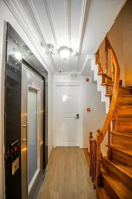 a hallway with a staircase and a white door at Linfer Hotel Taksim in Istanbul