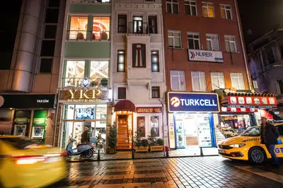 a city street at night with cars and buildings at Linfer Hotel Taksim in Istanbul