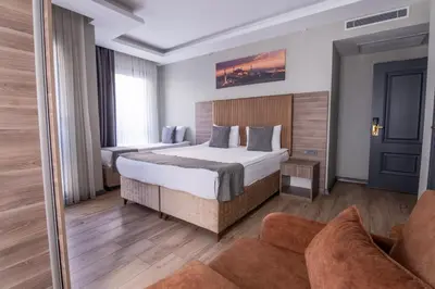 a hotel room with a bed and a couch at The Omiya Hotel in Istanbul
