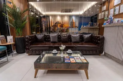 a living room with a leather couch and a coffee table at The Omiya Hotel in Istanbul