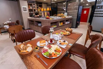 a table with plates of food on it in a restaurant at The Omiya Hotel in Istanbul
