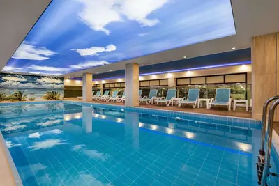 a large swimming pool with a ceiling that has a sky at Ramada Plaza by Wyndham Silivri in Silivri