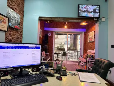 a desk with a computer monitor and a keyboard and mouse at Elegance Aparts Cihangir in Istanbul