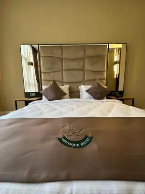 a large white bed with a hotel sign on it at Berfinn Hotel Ortaköy in Istanbul