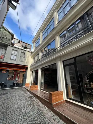 a building with a balcony on the side of it at Berfinn Hotel Ortaköy in Istanbul