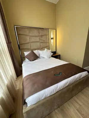 a bedroom with a large bed with a large headboard at Berfinn Hotel Ortaköy in Istanbul