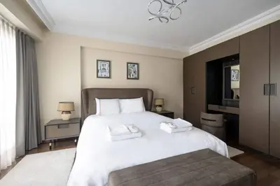 a bedroom with a large white bed and a television at Lovely bright central modern 1Bed1Bath! #159 in Istanbul