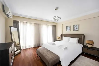 a bedroom with a large white bed and a television at Lovely bright central modern 1Bed1Bath! #159 in Istanbul