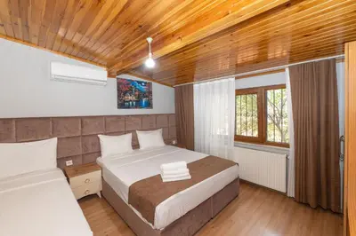 a bedroom with two beds and a wooden ceiling at Terra Apart Taksim in Istanbul