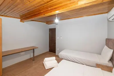 a bedroom with white walls and a wooden ceiling at Terra Apart Taksim in Istanbul