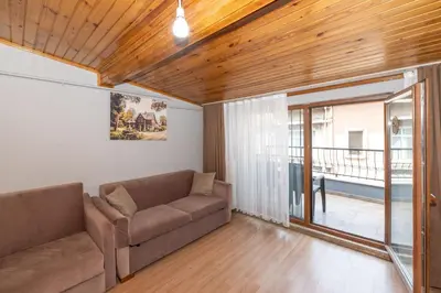 a living room with a couch and a balcony at Terra Apart Taksim in Istanbul