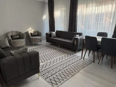 a living room with a couch and a table and chairs at Only For Families Apartment in Istanbul