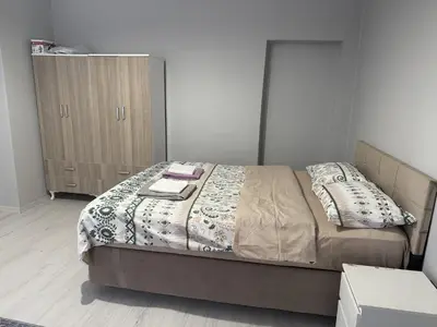 a bedroom with a bed and a wooden cabinet at Only For Families Apartment in Istanbul