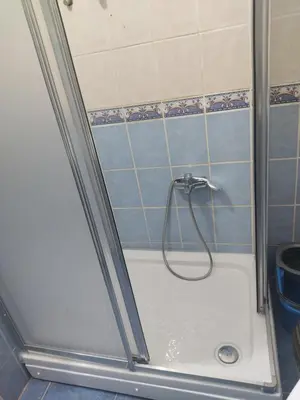 a shower with a hose in a bathroom at Only For Families Apartment in Istanbul