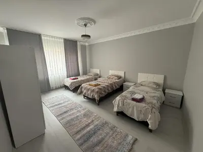 a bedroom with two beds and a rug at Only For Families Apartment in Istanbul