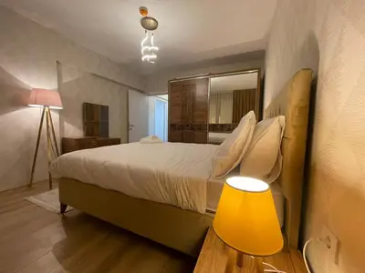 a bedroom with a large bed and a yellow lamp at King Suite ZG5 in Esenyurt