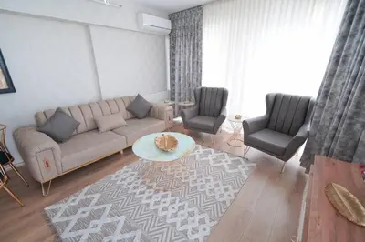 a living room with a couch and two chairs at King Suite ZG5 in Esenyurt
