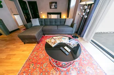 a living room with a couch and a table on a rug at Hexa Suites Hotel in Istanbul