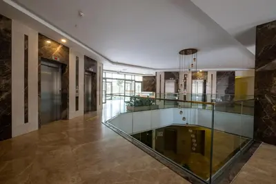 a glass elevator in a building with a lobby at Linkinn Luxury Residence & Spa in Esenyurt