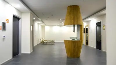 a hallway of an office with a wooden table in the middle at Linkinn Luxury Residence & Spa in Esenyurt