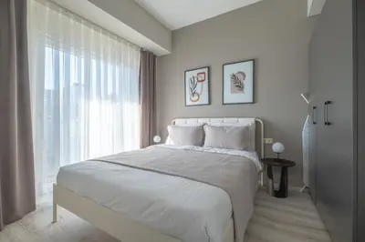 a white bedroom with a large bed and a window at Linkinn Luxury Residence & Spa in Esenyurt