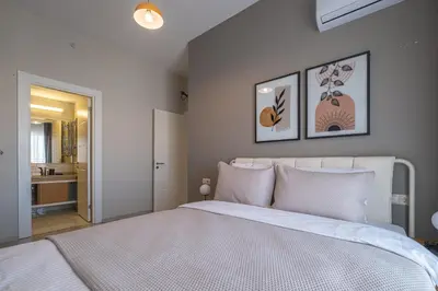 a bedroom with a white bed with two pictures on the wall at Linkinn Luxury Residence & Spa in Esenyurt