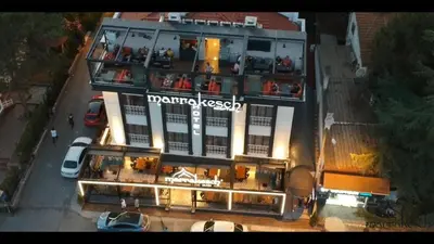 a large building with a sign on top of it at Marrakeschotel in Tuzla