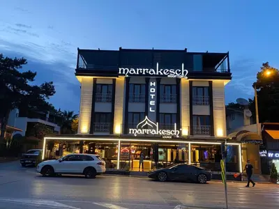 a building with two cars parked in front of it at Marrakeschotel in Tuzla