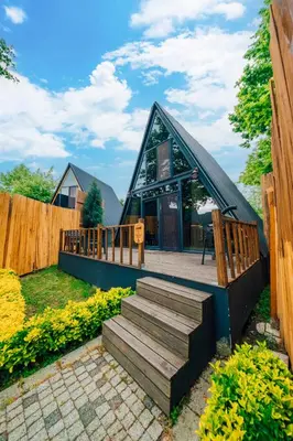 a small house with a wooden roof and stairs at Kurtköy Park Bungalov Evleri in Sakarya