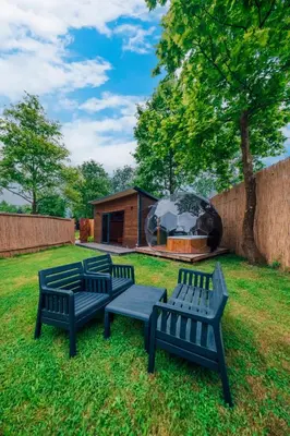 a group of benches sitting in the grass in a yard at Kurtköy Park Bungalov Evleri in Sakarya