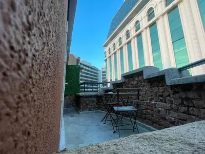 a balcony with chairs and tables on a building at EA Exclusive Hotel in Istanbul