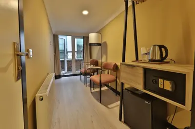 a living room with a table and chairs in a room at EA Exclusive Hotel in Istanbul